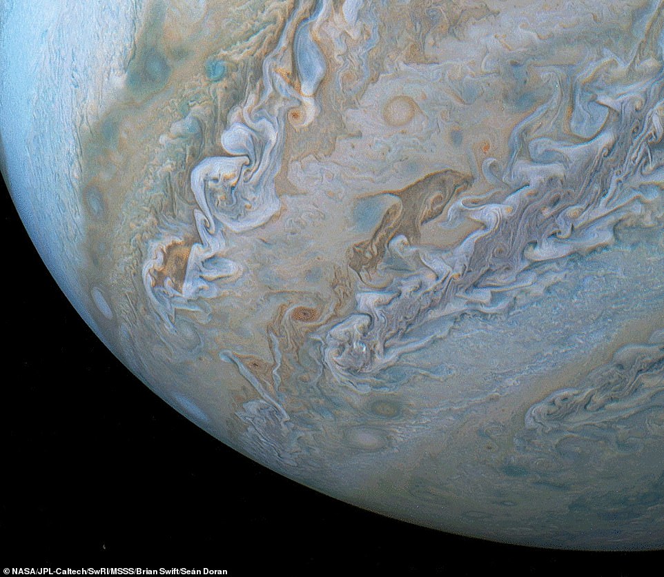 6958708-6481141-a_breathtaking_new_image_series_captured_by_nasa_s_juno_spacecra-a-45_1544479860230 A breathtaking new image series captured by NASA’s Juno spacecraft has revealed a look at a dolphin-shaped cloud that appears to be jumping through Jupiter’s atmosphere. It can be seen in the image above, just to the right of center
