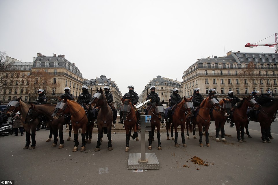7457764-6498733-image-a-30_1544869625955 A unit of mounted police officers stand guard in front of the Opera during the Yellow Vest demonstration today