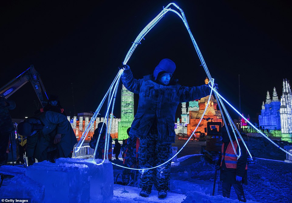 7894982-6535251-image-a-54_1545996802783 Race with time:Â Latest pictures show workers painstakingly carving large chunks of ice and building the ice structures
