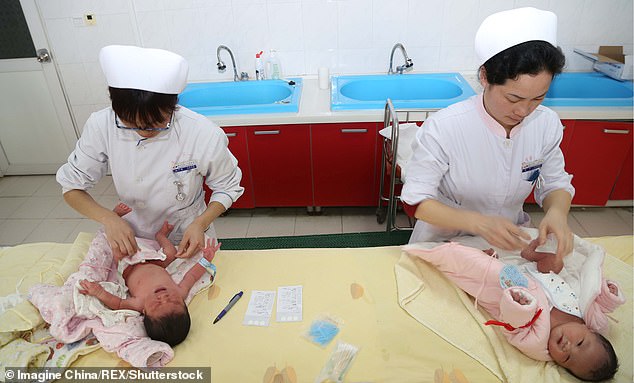 8086510-6554127-image-m-50_1546520130971 Chinese midwives take care of newborn babies at a hospital in Xiangyang city, China
