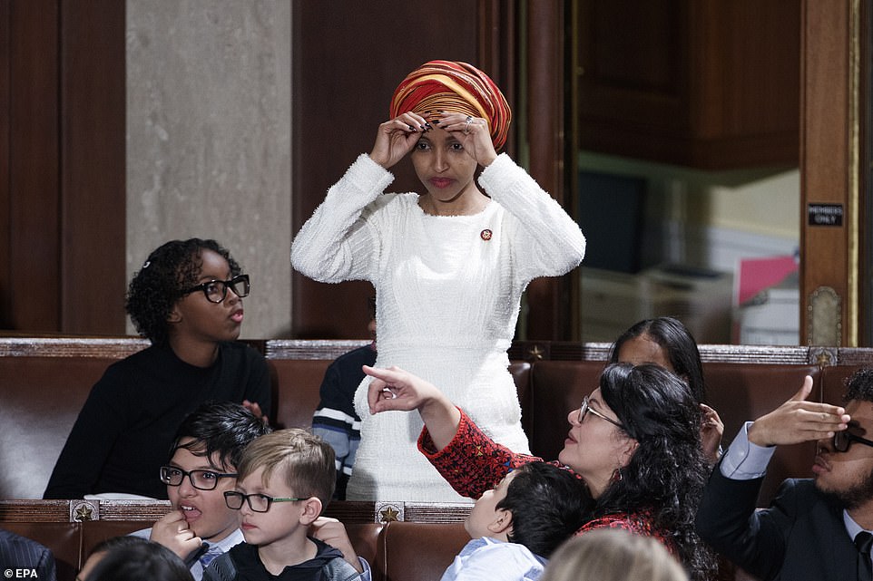 8099288-6555271-image-a-144_1546545278926 Getting used to the new scene: Ilhan Omar adjusts the hijab she is allowed to wear on the floor thanks to changed rules