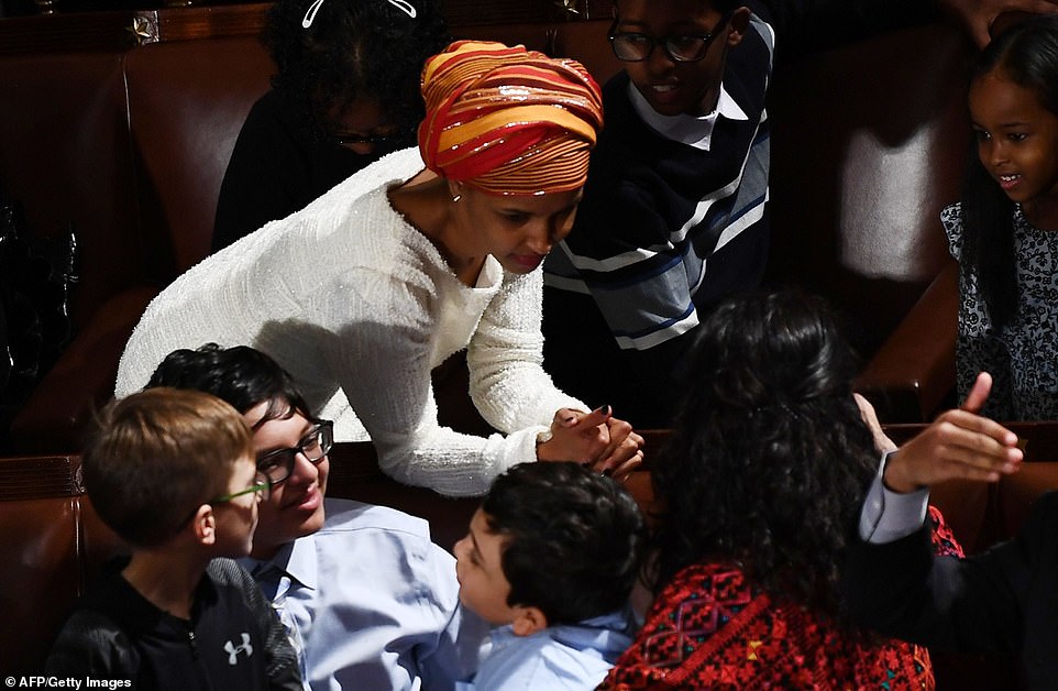8099300-6555271-image-a-120_1546544310721 Chat time: Ilhan Omar and other members of Congress took the chance to mingle and talk before the House entered its new session