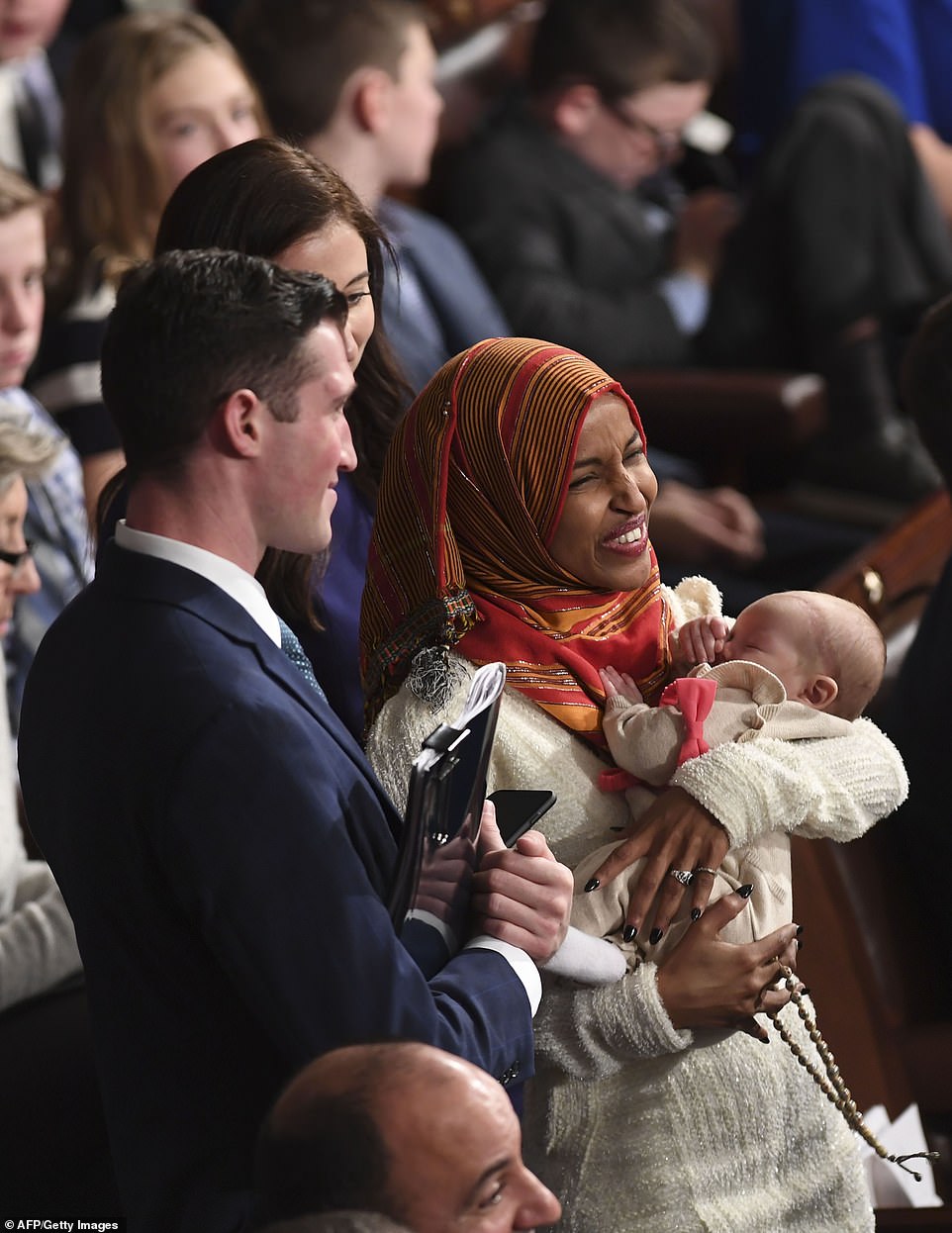 8100488-6555271-image-a-135_1546544460200 In power: Ilhan Omar posed with Eric Swalwell's young baby and held in her hand a set of Islamic prayer beads