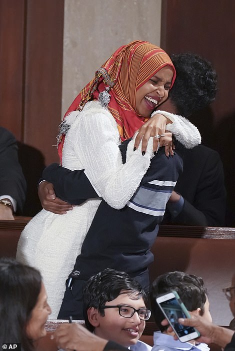 8110296-6555271-rep_ilhan_omar_embraces_her_oldest_son_after_she_was_sworn_by_ne-a-12_1546564342439 Rep. Ilhan Omar embraces her oldest son after she was sworn by new House Speaker Nancy Pelosi on Thursday