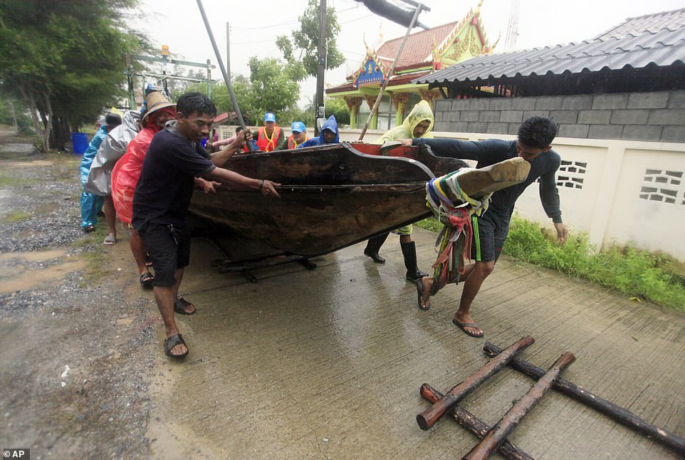 8118070-6556803-local_fishermen_move_a_boat_ashore_in_preparation_for_the_approa-a-8_1546598350555 Local fishermen move a boat ashore in preparation for the approaching Tropical Storm Pabuk