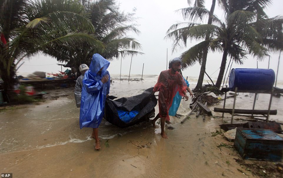 8118110-6556803-locals_clear_the_shoreline_in_preparation_for_the_approaching_tr-a-7_1546598350546 Locals clear the shoreline in preparation for the approaching Tropical Storm Pabuk, in Pak Phanang, in the southern province of Nakhon Si Thammarat, southern Thailand