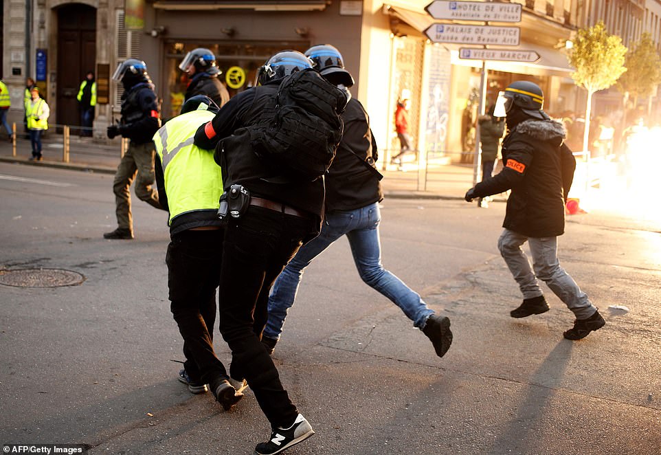 8157800-0-image-a-2_1546691365003 A yellow vest anti-government protestor is detained by security personnel in Rouen, north-western France on January 5, 2019, during a nationwide day of demonstrations