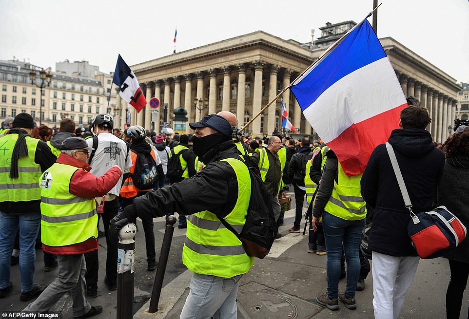8157814-0-image-a-15_1546691509384 Crisis-ridden Mr Macron has not only climbed down on imposing green surcharges, but increased the national minimum wage by seven per sent, and scrapped tax on bonuses. Pictured are protestors in Paris today