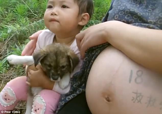 Zhang Xinlei sits with her pregnant mother. Her parents attempted to have another child to get umbilical cord blood for her, but they realised they wouldn't be able to afford the transplant
