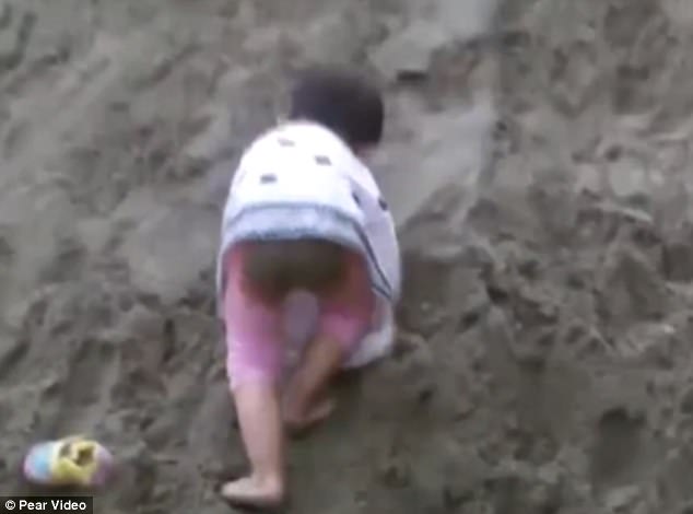 Zhang Xin-lei is brought to play at the burial place as her father hopes that she will feel comfortable with the grave and won't be so fearful when the moment comes