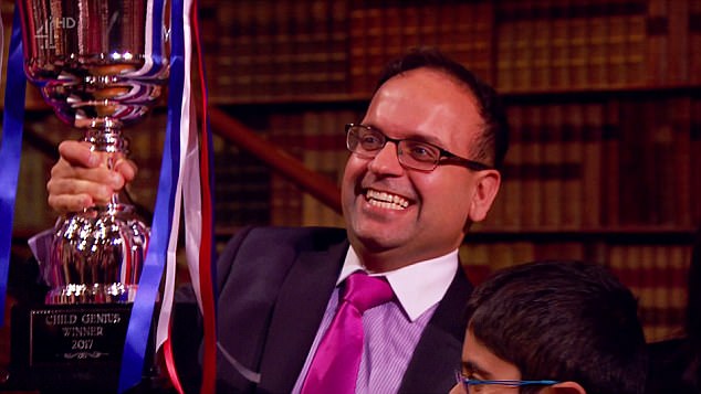 Minesh Doshi proudly holds up his son Rahul's trophy after winning 10 points to four to beat nine year-old Ronan