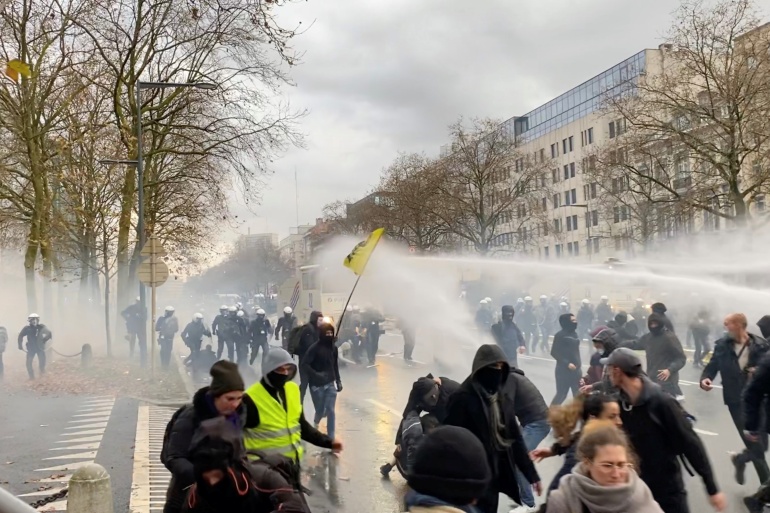 arh-1 Demonstrators run away from water cannons during a protest, in Brussels, Belgium, November 21, 2021, in this still image obtained from a social media video. Twitter/@jordynuyts/via REUTERS THIS IMAGE HAS BEEN SUPPLIED BY A THIRD PARTY. MANDATORY CREDIT. NO RESALES. NO ARCHIVES.
