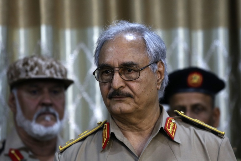 General Khalifa Haftar speaks during a news conference at a sports club in Abyar, a small town to the east of Benghazi May 21, 2014. Haftar called on the government to hand over power to the country's top judges, mounting a challenge against Tripoli as heavy fighting erupted in the capital on Wednesday. Western powers fear a call by Haftar for army units to join his campaign will split the nascent military and trigger more turmoil in the oil producing country which is struggling to restore order three years after the fall of strongman Muammar Gaddafi. REUTERS/Esam Omran Al-Fetori (LIBYA - Tags: CIVIL UNREST POLITICS MILITARY)