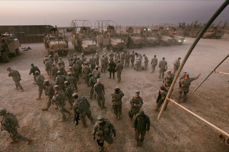 epa03037147 An image made available on 18 December 2011 shows US soldiers from the 3rd Brigade, 1st Cavalry Division depart a mission brief on their way to perform perimeter security at Camp Adder, now known as Imam Ali Base near Nasiriyah, Iraq on 16 December 2011 Around 500 troops from the 3rd Brigade, 1st Cavalry Division ended their presence on Camp Adder, the last remaining American base, and departed in the final American military convoy out of Iraq, arriving into Kuwait in the early morning hours of 18 December 2011. All U.S. troops were scheduled to have departed Iraq by 31 December 2011. At least 4,485 U.S. military personnel died in service in Iraq. According to the Iraq Body Count, more than 100,000 Iraqi civilians have died from war-related violence.  EPA/MARIO TAMA / POOL