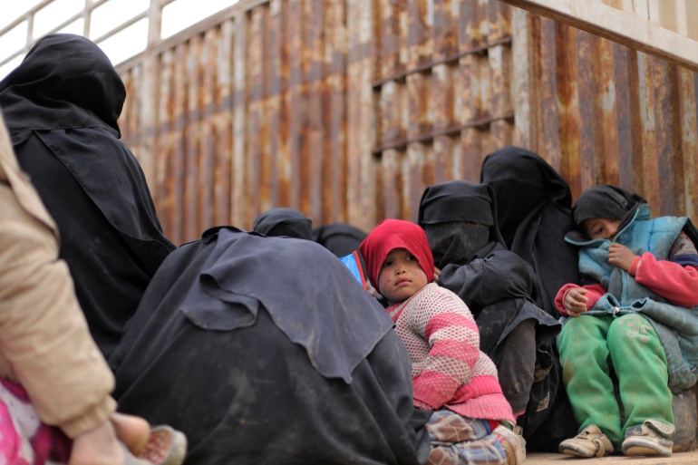 Children sit on the back of a truck near the village of Baghouz, Deir Al Zor province, in Syria March 7, 2019. Picture taken March 7, 2019. REUTERS/Rodi Said