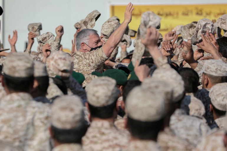 زيارة ملك الأردن عبد الله الثاني للمنطقة العسكرية الشرقية على الحدود الأردنية السورية Jordan's King Abdullah II greets army members during his visit to the Eastern Military Zone along the Jordan-Syrian border, Jordan February 14, 2022. Picture taken February 14, 2022. Jordanian Royal Palace/Handout via Reuters ATTENTION EDITORS - THIS IMAGE HAS BEEN SUPPLIED BY A THIRD PARTY. NO RESALES. NO ARCHIVES