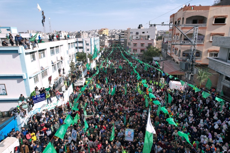 Palestinians take part in a rally marking the 34th anniversary of Hamas' founding, in the northern Gaza Strip