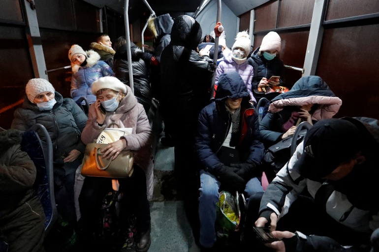 People are seen inside a bus arranged to evacuate local residents, in the rebel-controlled city of Donetsk, Ukraine February 18, 2022. REUTERS/Alexander Ermochenko
