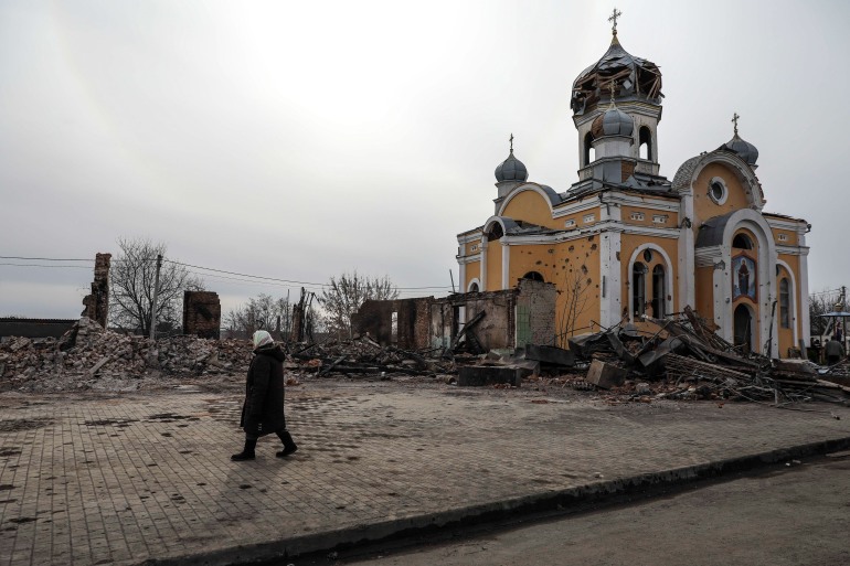 h_57543642 epa09819961 A woman passes near the Rus Orthodox Foreign Church partially destroyed after being bombed by Russian aircraft, in Malyn, Ukraine, 12 March 2022. Russian troops entered Ukraine on 24 February prompting the country's president to declare martial law and triggering a series of announcements by Western countries to impose severe economic sanctions on Russia. EPA-EFE/MIGUEL A. LOPES
