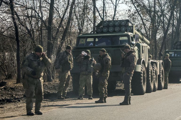 rts5r8fs-1-1 Ukrainian army soldiers stand next to multiple launch missile systems in Kharkiv region