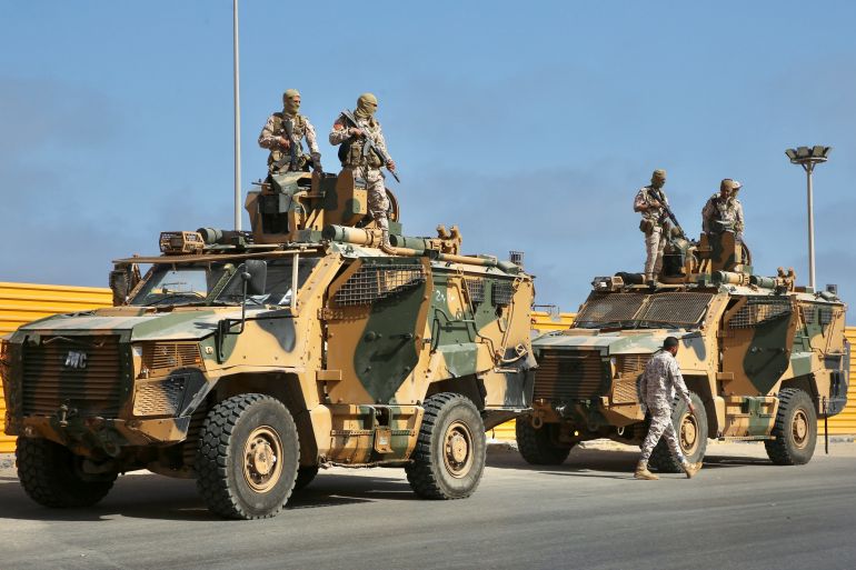 rts7wmpb-1 Soldiers loyal to the head of Libya's Government of National Unity, Abdulhamid al-Dbeibah, stand on military vehicles in Tripoli