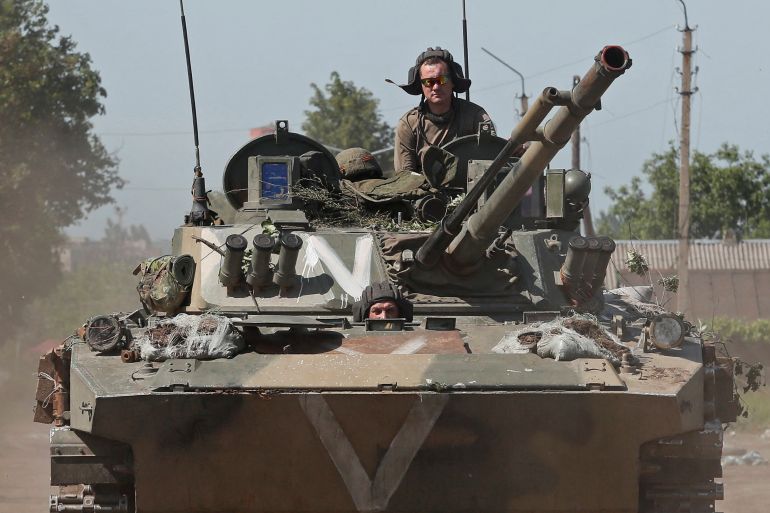 rts8cs4c-1-1 Service members of pro-Russian troops ride an infantry fighting vehicle in Popasna