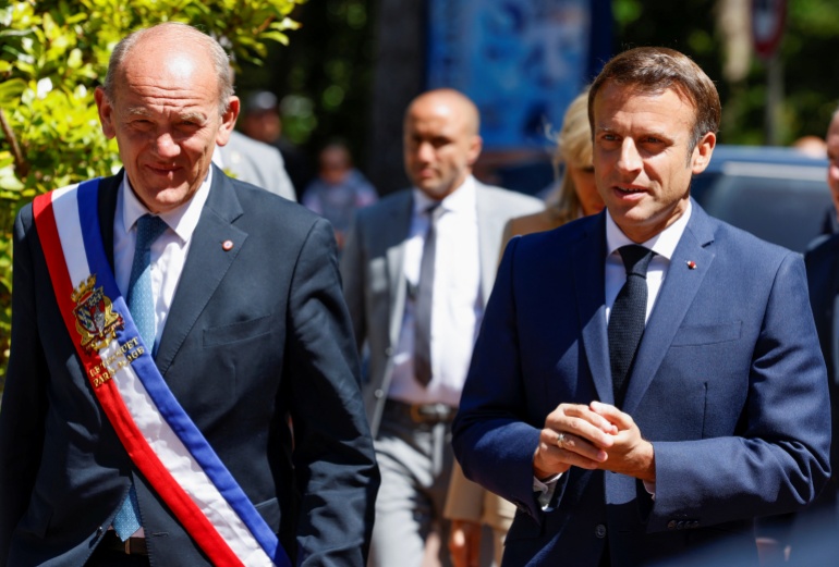 French President Macron votes in the first round of French parliamentary elections