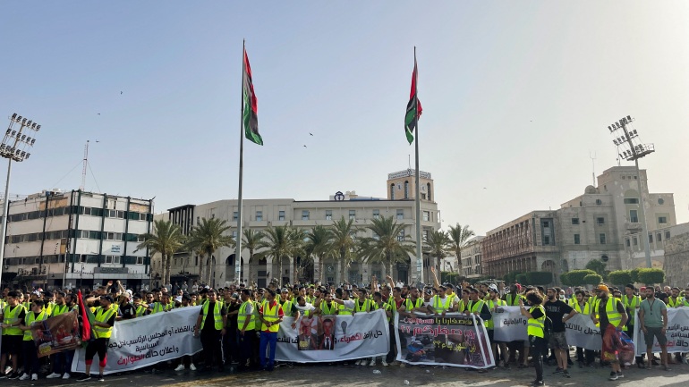 People protest against a power outage inside Martyrs' Square, in Tripoli