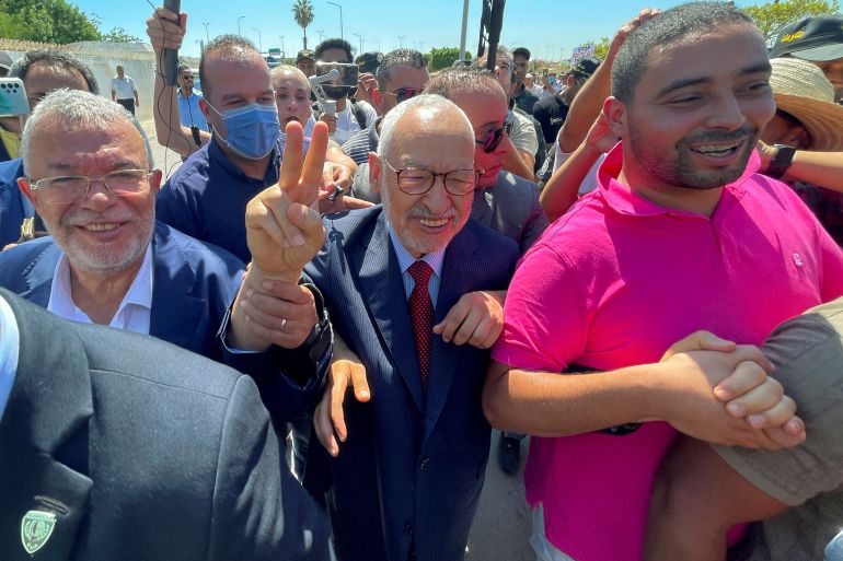 rts9pjsf-1 Tunisia's Islamist movement leader Rached Ghannouchi gestures upon arrival at court in Tunis