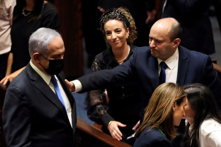 rtxd8g2y-1 Head of opposition Benjamin Netanyahu and Israel Prime Minister Naftali Bennett gesture following the vote on the new coalition at the Knesset, Israel's parliament, in Jerusalem
